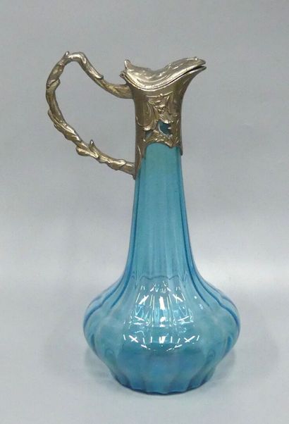 A blue glass ewer with gadroon motifs
and...