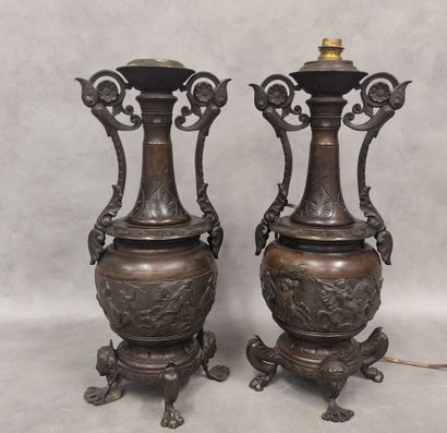 A pair of regula vases with handles, decorated...