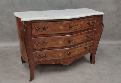 a three-drawer chest of drawers in rosewood...