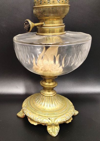 A kerosene lamp with fluted glass reservoir
Bronze...