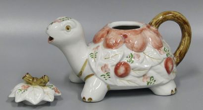 A white ceramic turtle-shaped teapot decorated...