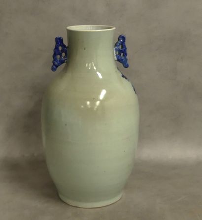 A large ceramic vase with two handles decorated...