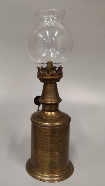 Two Pigeon lamps, one with its glass, the...