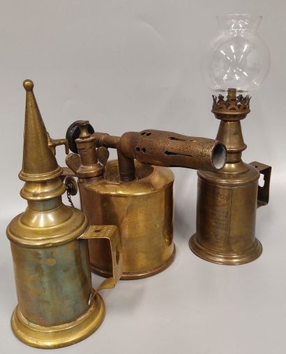 Two Pigeon lamps, one with its glass, the...