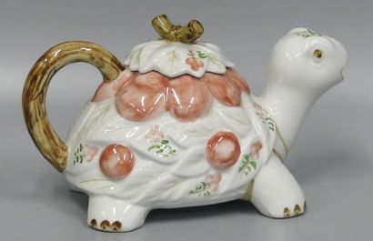 A white ceramic turtle-shaped teapot decorated...