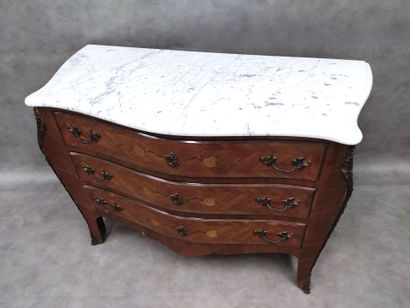 a three-drawer chest of drawers in rosewood...