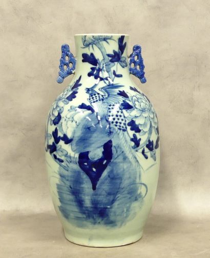 A large ceramic vase with two handles decorated...