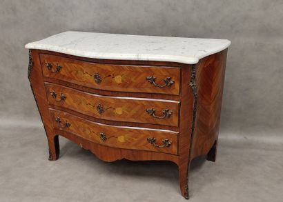 a three-drawer chest of drawers in rosewood...