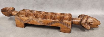 An awale game tray decorated with a ram's...