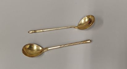 Two small vermeil spoons with different decorations,...