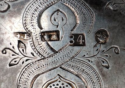 Flat silver case engraved with scrolls and...