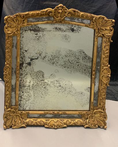 Gilded carved wood mirror with foliage and...