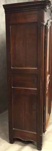 Gendarme-cap cabinet in molded walnut, opening...