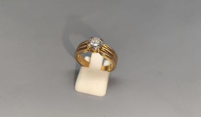 Yellow gold ring set with a modern-cut diamond...