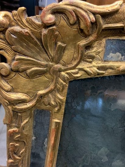 Gilded carved wood mirror with foliage and...