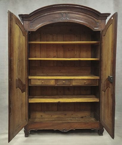 Gendarme-cap cabinet in molded walnut, opening...