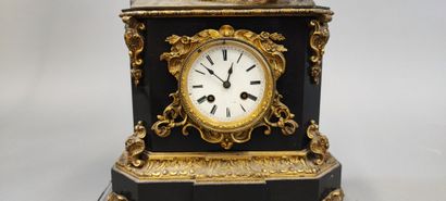 Black marble clock surmounted by an oriental-style...