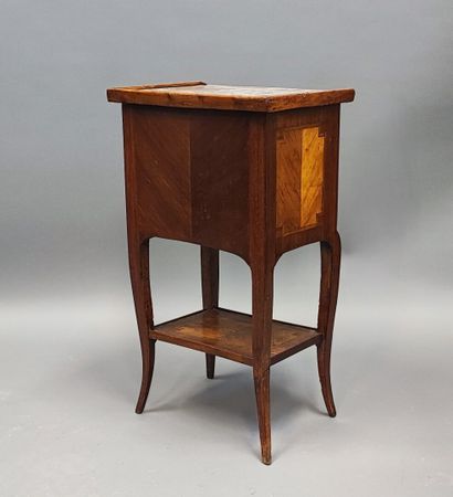 Veneered bedside table opening with three...