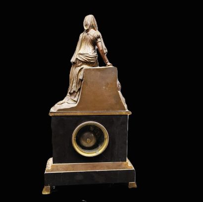 Black marble clock surmounted by an oriental-style...