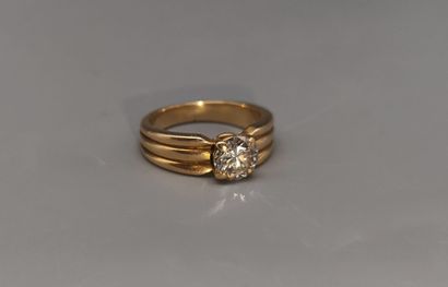 Yellow gold ring set with a modern-cut diamond...