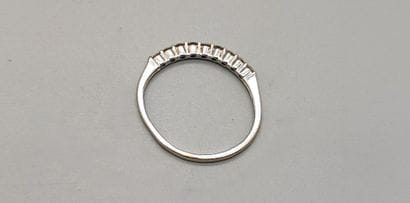 Half-American wedding band in white gold...