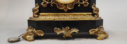 Black marble clock surmounted by an oriental-style...