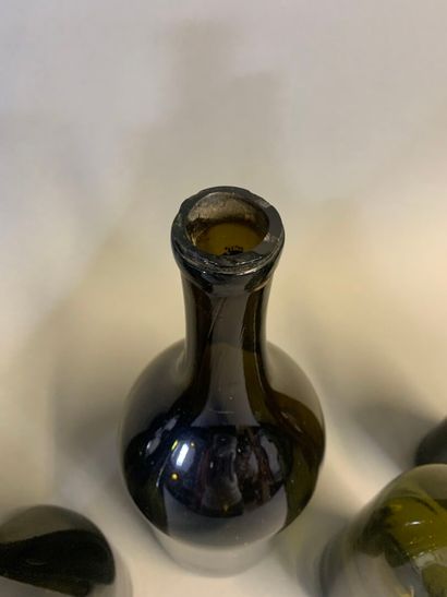 Seven antique bottles, mouth-blown olive...