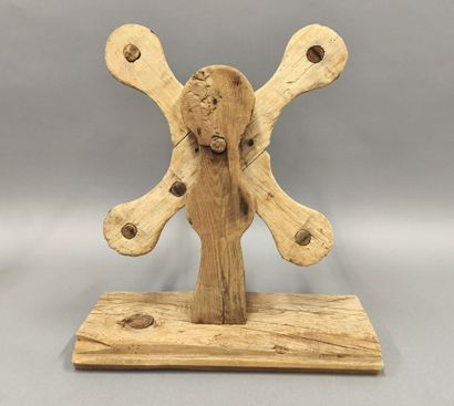 Wooden wool reel with four wings.