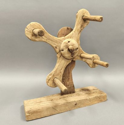 Wooden wool reel with four wings.