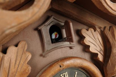 Carved wooden cuckoo clock with two pine...
