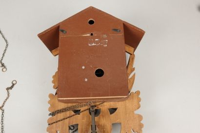 Carved wooden cuckoo clock with two pine...