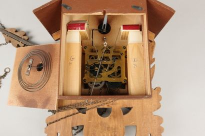 Carved wooden cuckoo clock with two pine...