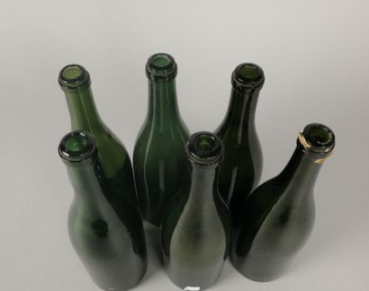 Six Champagne-shaped bottles in glass of...