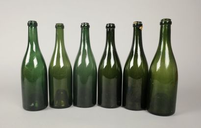 Six Champagne-shaped bottles in glass of...