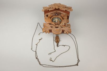 Carved wooden cuckoo clock with two pine...