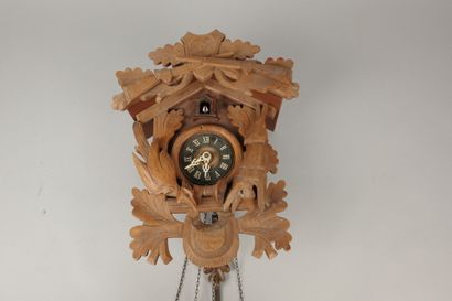 Carved wooden cuckoo clock with two pine...