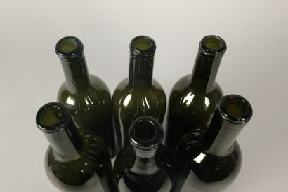 Six Bordeaux-shaped bottles in glass of various...