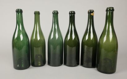 Six Champagne-shaped bottles in glass of...