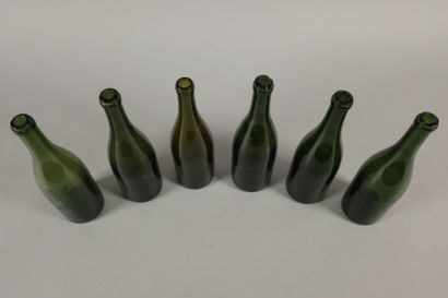 Six Champagne-shaped bottles in glass of...
