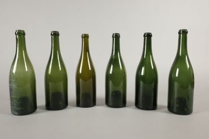 Six Champagne-shaped bottles in glass of...