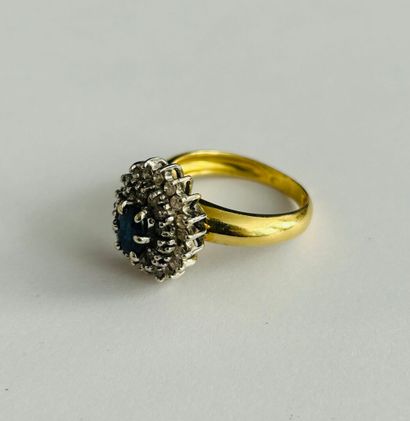 Ring set with an oval sapphire in a double...