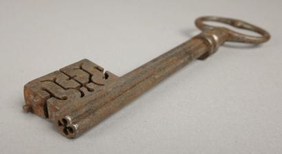 Wrought-iron key with an oval ring featuring...