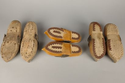 Three pairs of wooden clogs with leather...