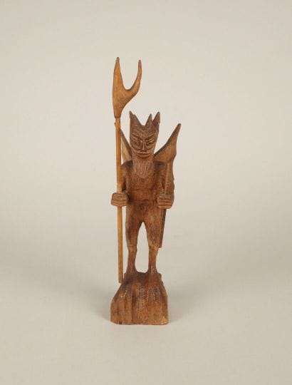 20th century. Winged devil holding pitchfork...