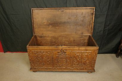 Natural wood cabinet with a carved three-panel...