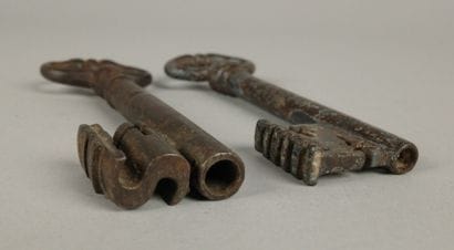 Two wrought-iron keys, one with an oval ring...