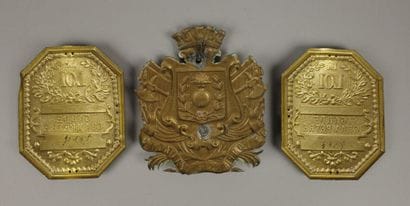 Two stamped brass plaques reading 