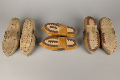 Three pairs of wooden clogs with leather...