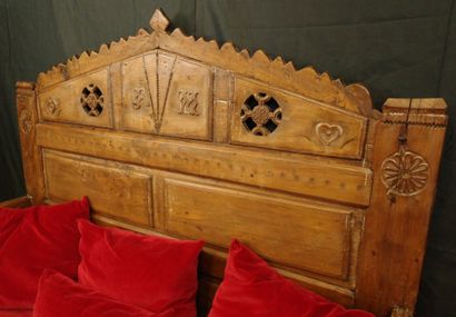 Daybed with a solid, crenellated headboard...