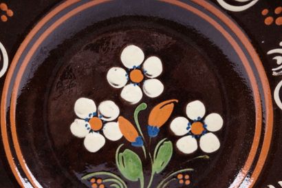 Glazed ceramic dish with a polychrome floral...